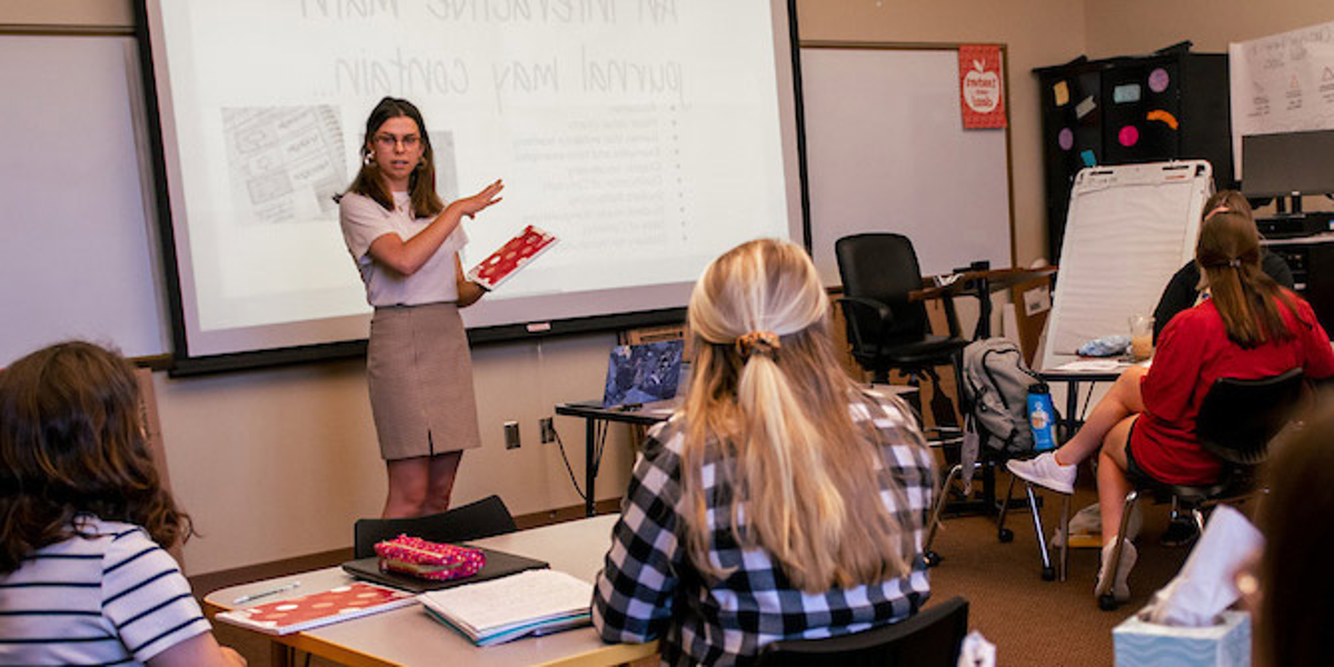 A female student presenting to the class